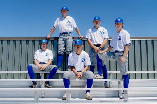Baseball players wearing Richardson team hats and uniforms
